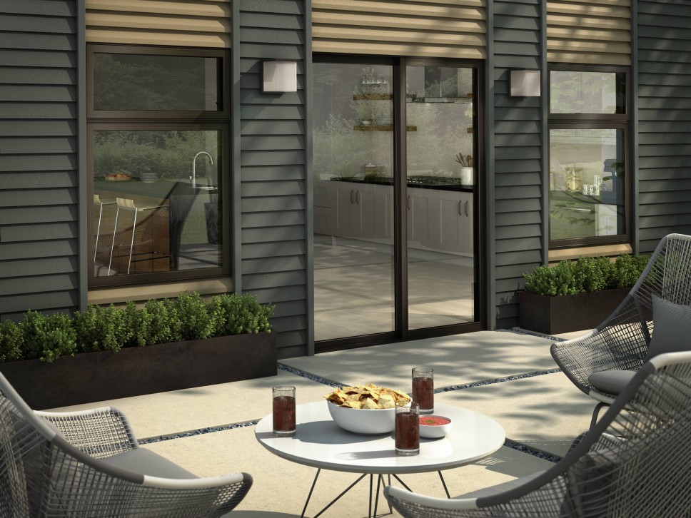 Outside patio of a home with three chairs surrounding a small table with snacks and drinks on top